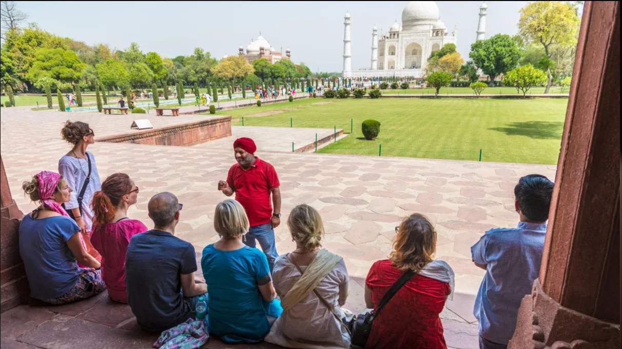 Indian local tour guide introducing travellers to a famous heritage destination.
